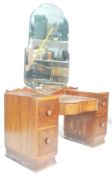 A 1930's Art Deco twin pedestal walnut dressing table. The dressing table with shaped bevelled