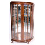 A 1930's Queen Anne walnut half moon / demi lune china display cabinet vitrine with glass shelves