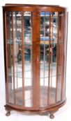 A 1930's Queen Anne walnut half moon / demi lune china display cabinet vitrine with glass shelves