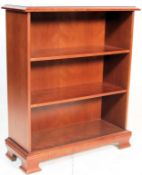 A good quality Queen Anne revival  mahogany open window bookcase having  a flared edge and shaped