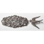 A silver hallmarked marcasite bar brooch with floral decoration and makers mark to the back for