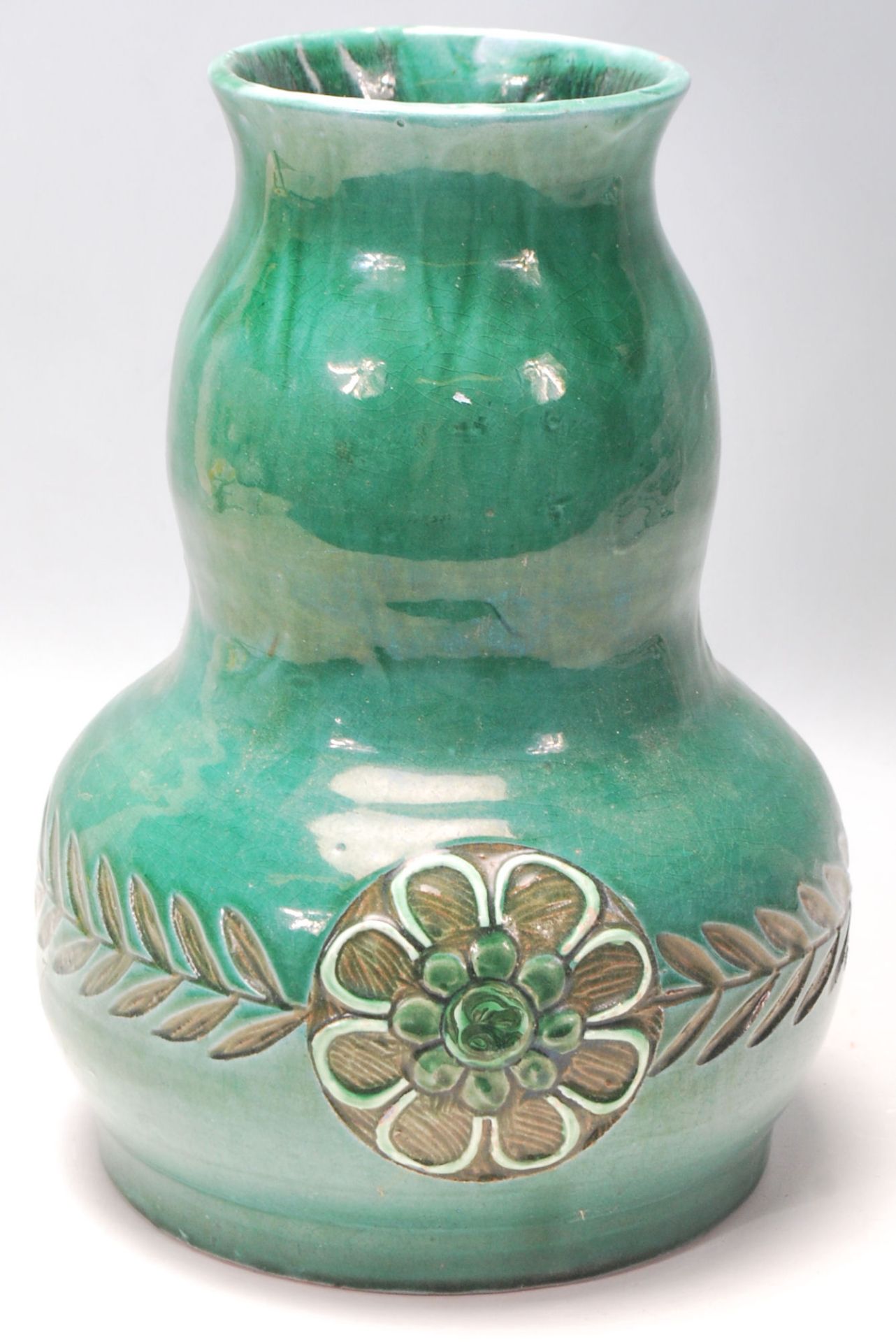 An early 20th Century Devonia Art Fremington Barum terracotta vase by Ed Judler in a bulbous form