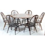 An vintage retro 20th Century Ercol elm golden dawn dining table and chairs having a round topped