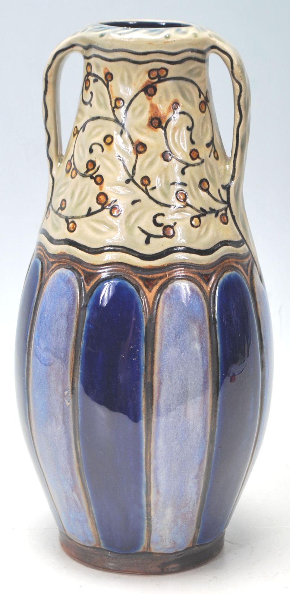 An early 20th Century Royal Doulton Lambeth stoneware large mantel vase in tapered form having