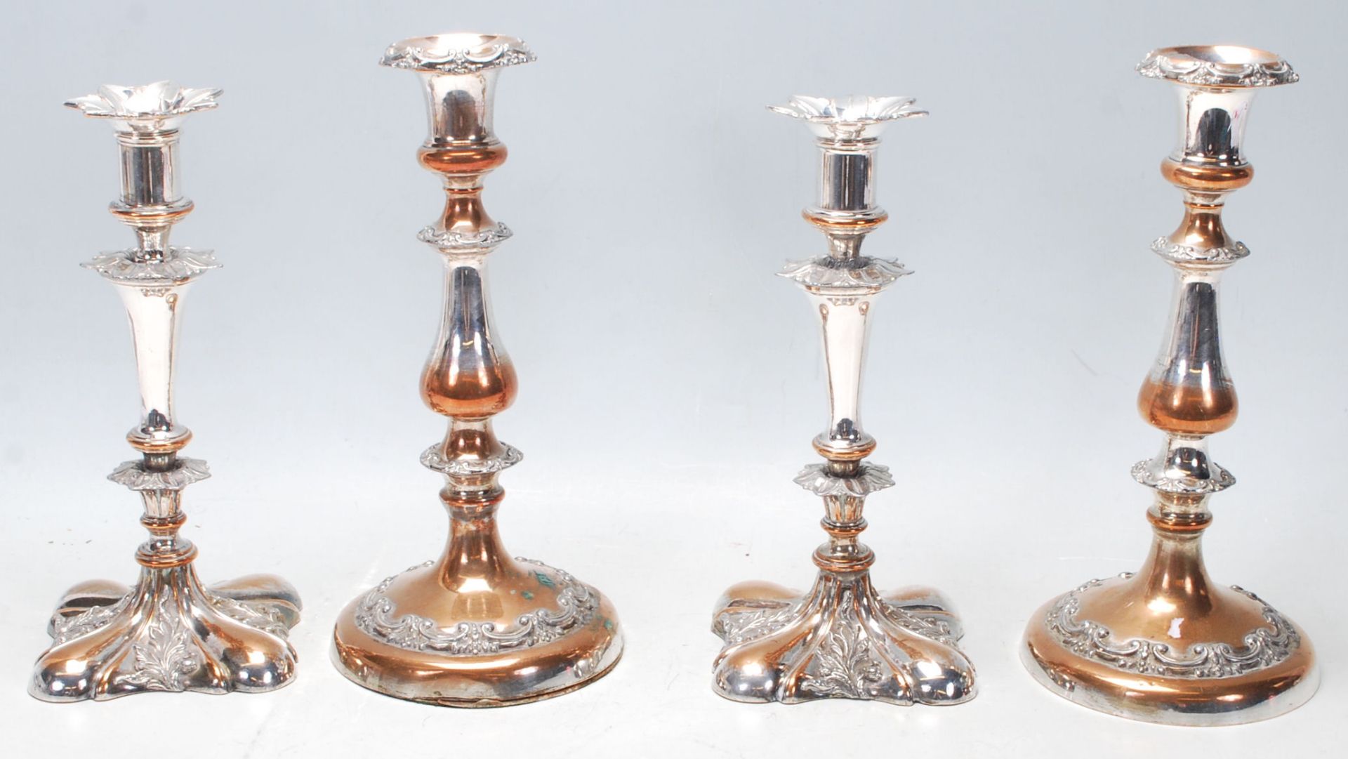 Two pairs of 20th Century silver plated candlesticks to include one pair having round bases with