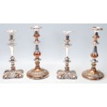 Two pairs of 20th Century silver plated candlesticks to include one pair having round bases with