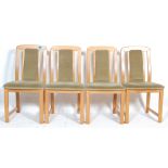 A set of four vintage retro 20th Century beech wood dining chairs having velour upholstered back and