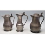 A group of 19th century Victorian pewter jugs with seashell and acorn decoration
