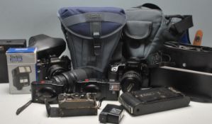 A collection of vintage cameras to include a Canon Eos 100 film camera with a 28-80mm lens, a