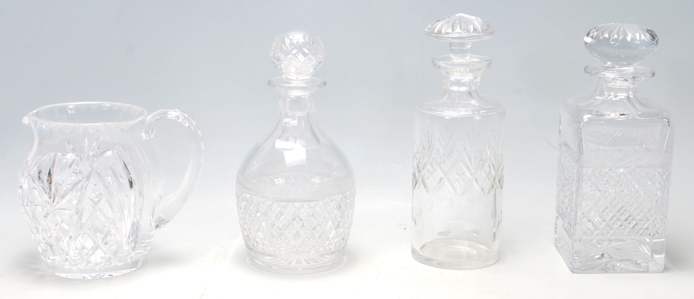 A group of 20th Century cut glass decanters to include a whiskey decanter...