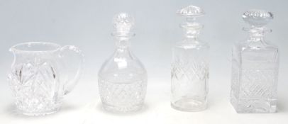 A group of 20th Century cut glass decanters to include a whiskey decanter, bottle decanter, and