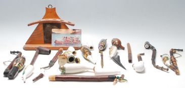 A collection of vintage German porcelain smoking lidded pipes with ceramic bowl and wooden stem,