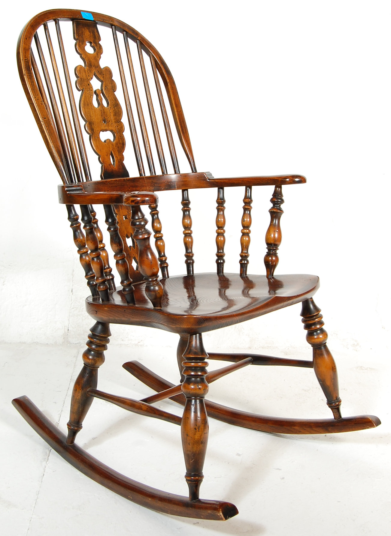 A good quality reproduction 19th Century Victorian Windsor rocking chair having a hooped back with a