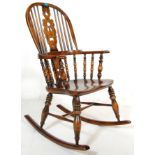A good quality reproduction 19th Century Victorian Windsor rocking chair having a hooped back with a