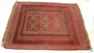 A good early 20th Century hand woven Persian / Islamic floor rug carpet having a red ground with