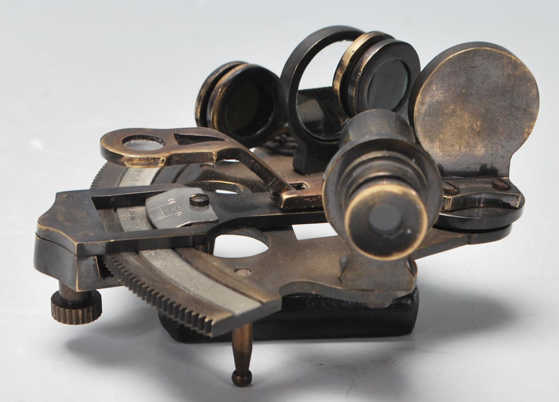 A 20th Century brass ships sextant having a wooden handle with a sighting telescope and horizon