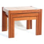 A 20th-century retro teak wood and tile top nest of three tables. The tables of graduating form