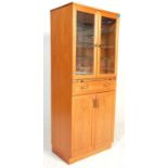 A vintage retro 20th Century G-Plan teak upright mirror backed double door cocktail cabinet