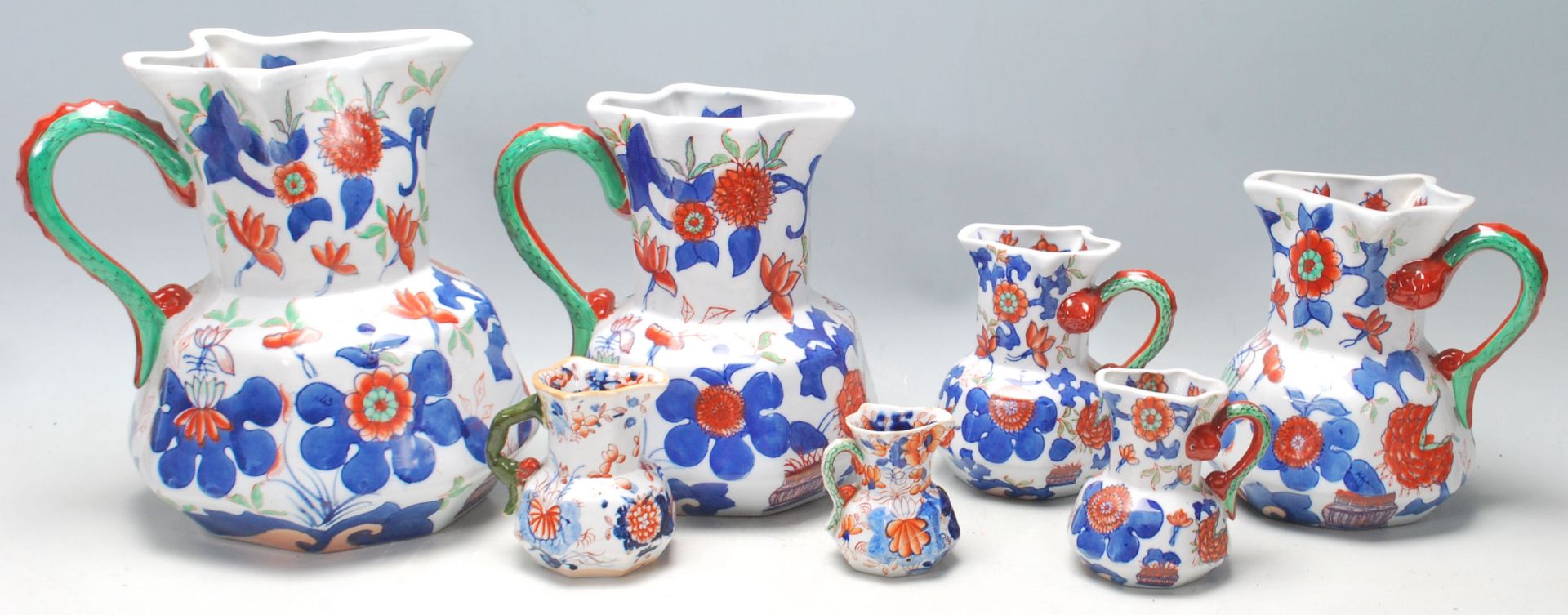 A group of seven early 19th Century graduated Mason patent Ironstone China jug having colourful