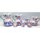 A group of seven early 19th Century graduated Mason patent Ironstone China jug having colourful