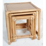 A retro vintage 20th Century bamboo / cane nest of graduating tables. Raised on bamboo supports