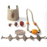 A selection of 20th Century North African white metal jewellery to include a beaded necklace