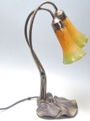 A 20th Century Tiffany style desk / table lamp having two yellow and green mottled glass shades