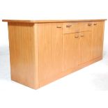 A retro vintage mid 20th Century Danish inspired teak sideboard credenza having shaped edges over