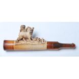 A good early 20th century cigarette cheroot holder with hand carved French bulldogs and amber