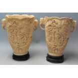 A pair of early 20th Century Chinese resin vases having raised landscape scenes to the body and