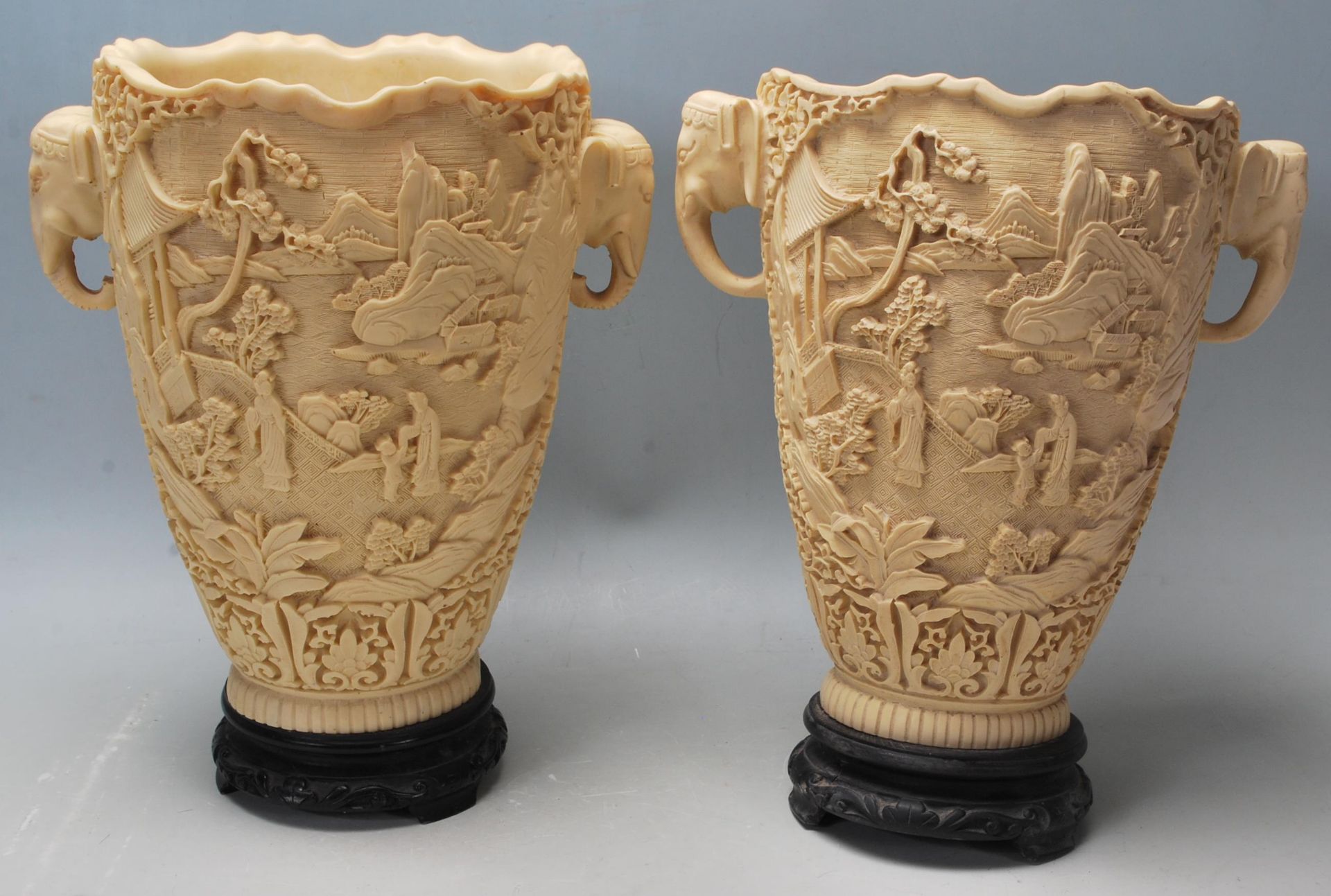 A pair of early 20th Century Chinese resin vases having raised landscape scenes to the body and