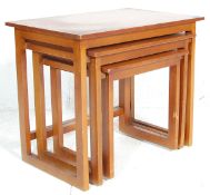 A 20th century nest of Danish inspired retro teak tables in the quadrille pattern. The tables each