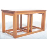 A vintage retro 20th century Danish inspired unusual teak wood nest of tables in the manner of