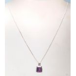 A hallmarked 18ct white gold pendant necklace having a fine snake chain with a square pendant