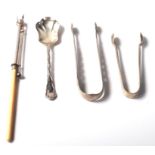 A selection of 20th Century silver hallmarked items to include a pair of sugar tong with engraved