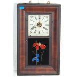 A late 19th century American mahogany wall clock of rectangular form having a square face to the top