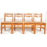 A set of 4 vintage 1950s mid Century pine country dining chairs with shaped ladder backs set on rush