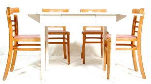 A vintage 20th Century shabby chic extending dining table of rectangular form being raised on