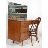 A retro vintage mid century teak wood dressing table desk with open kneehol recess flanked by a