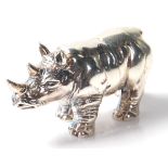 A Sterling silver cast figure of a rhinoceros. Stamped Sterling to the base. Weighs 19g. Measures