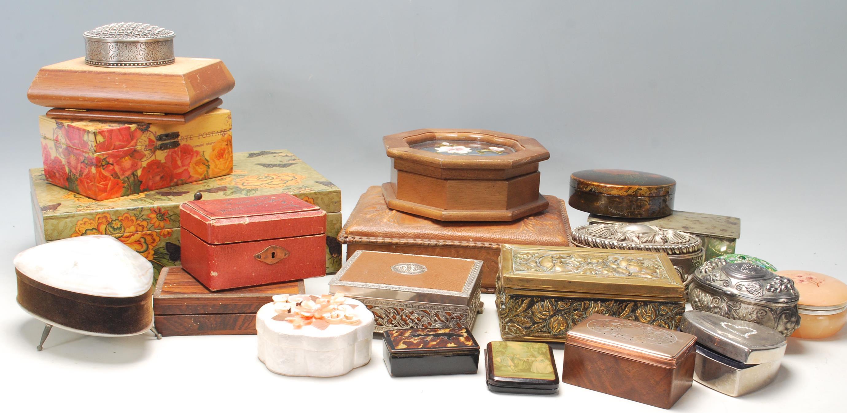 A large collection of vintage jewellery boxes to include wooden examples, white metal with relief