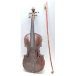 A 19th Century Victorian dark wood violin having  a hollow body with S shaped sound holes and