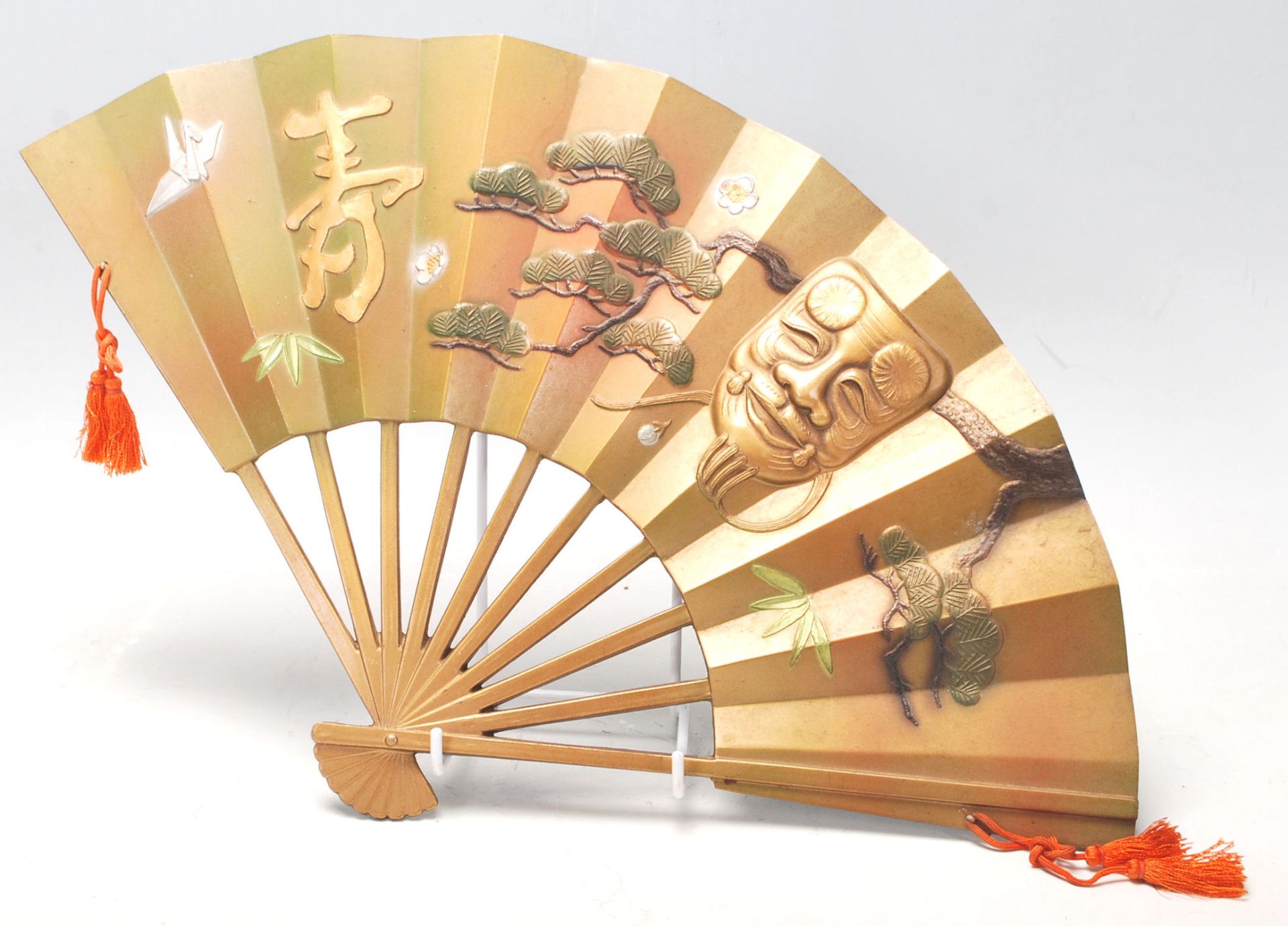 A 20th Century Chinese cast bronze wall mounting fan ornament having raised gilt and cold painted