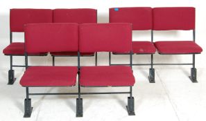 A set of three rows of retro folding 20th century cinema seats.  comprising of three rows with two