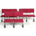 A set of three rows of retro folding 20th century cinema seats.  comprising of three rows with two