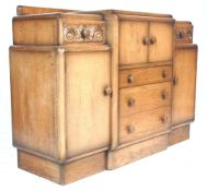 A vintage 1930's Art Deco oak breakfront sideboard having a stub stage gallery back over  twin