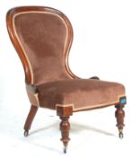 A 19th Century Victorian mahogany nursing chair / spoonback chair upholstered in chocolate brown