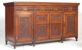 A 19th Century late Victorian oak sideboard dresser having a flared top over four drawers with brass