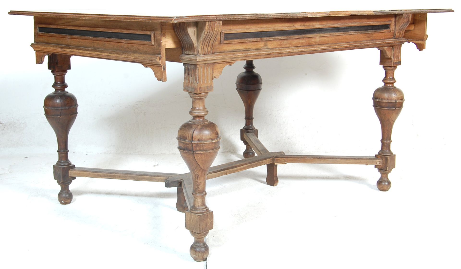 A 19th century Victorian French provincial oak extendable dining table. The table having cup and