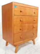 A vintage retro 1960's light / golden oak chest of drawers having a bank of four drawers having